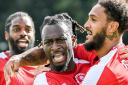 Martell Taylor-Crossdale (centre) celebrates his goal.