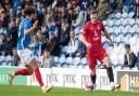 George Moore of Harrow Borough taking on Portsmouth's Marcus Harness at Fratton Park.