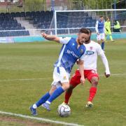 Wealdstone striker Danny Parish holds off Dagenham & Redbridge's Mauro Vilhete