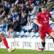 George Moore of Harrow Borough taking on Portsmouth's Marcus Harness at Fratton Park.