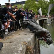 Protesters throw statue of Edward Colston into Bristol harbour during a Black Lives Matter protest rally. Photo: Ben Birchall/PA Wire.