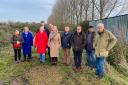 Liz Truss (centre) with villagers at the proposed West Dereham travellers' site