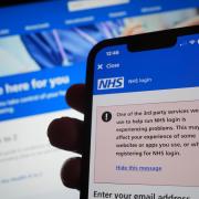 A warning message on the NHS app displayed on a phone as widespread IT outages are affecting businesses and institutions around the globe.