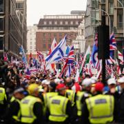 Supporters of a Pro-UK rally endorsed by Tommy Robinson march from Victoria Station to Parliament Square in central London.