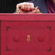 Chancellor Rachel Reeves holds up her ministerial red box (Lucy North/PA)