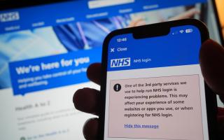 A warning message on the NHS app displayed on a phone as widespread IT outages are affecting businesses and institutions around the globe.